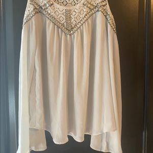 White long sleeve shirt with sleeves cut out.